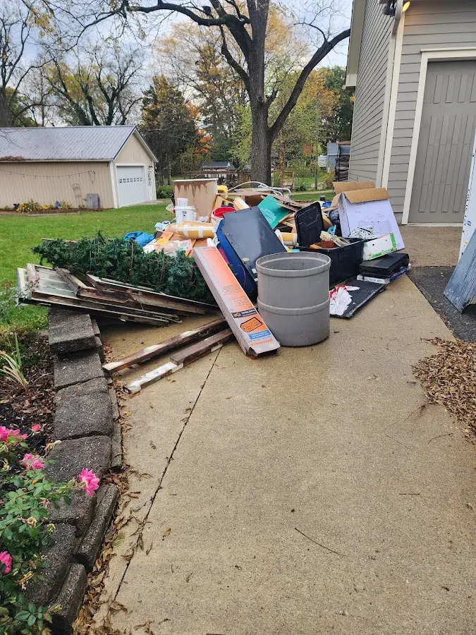 Dumpster being loaded with debris for Estate Cleanout Dumpster Rental in Newton